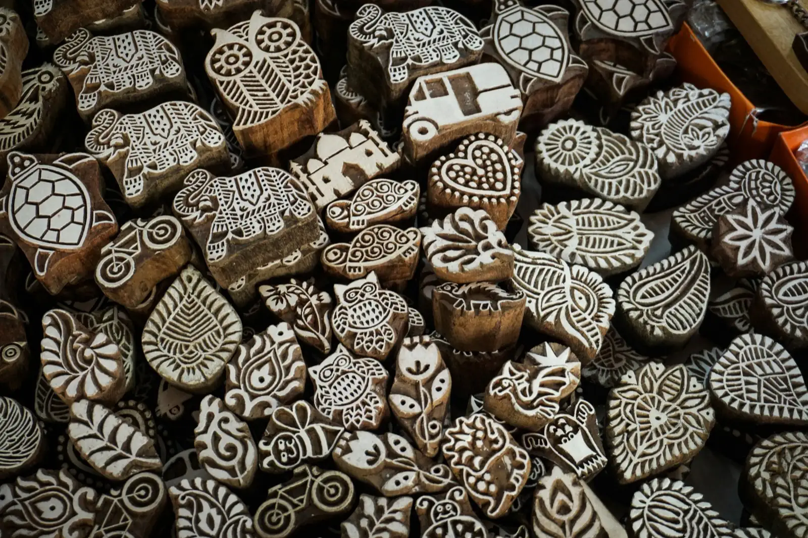 Hand-carved wooden printing blocks with floral and animal motifs