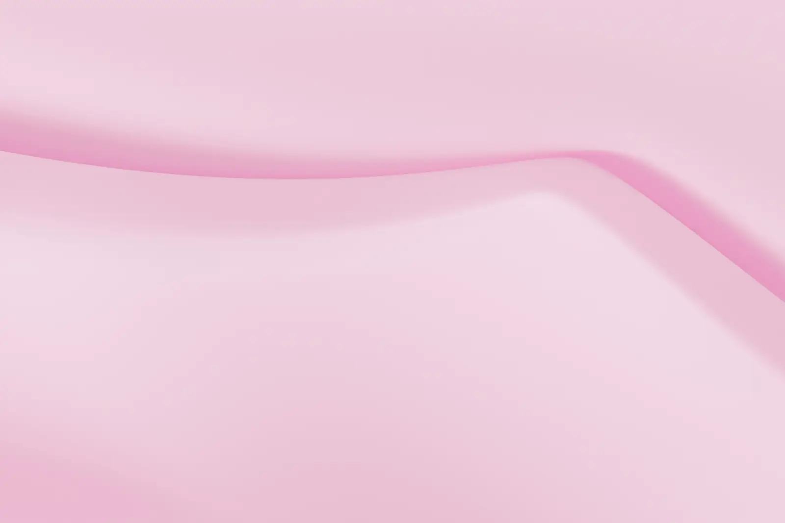 Soft folds of pale pink fabric with a gentle sheen