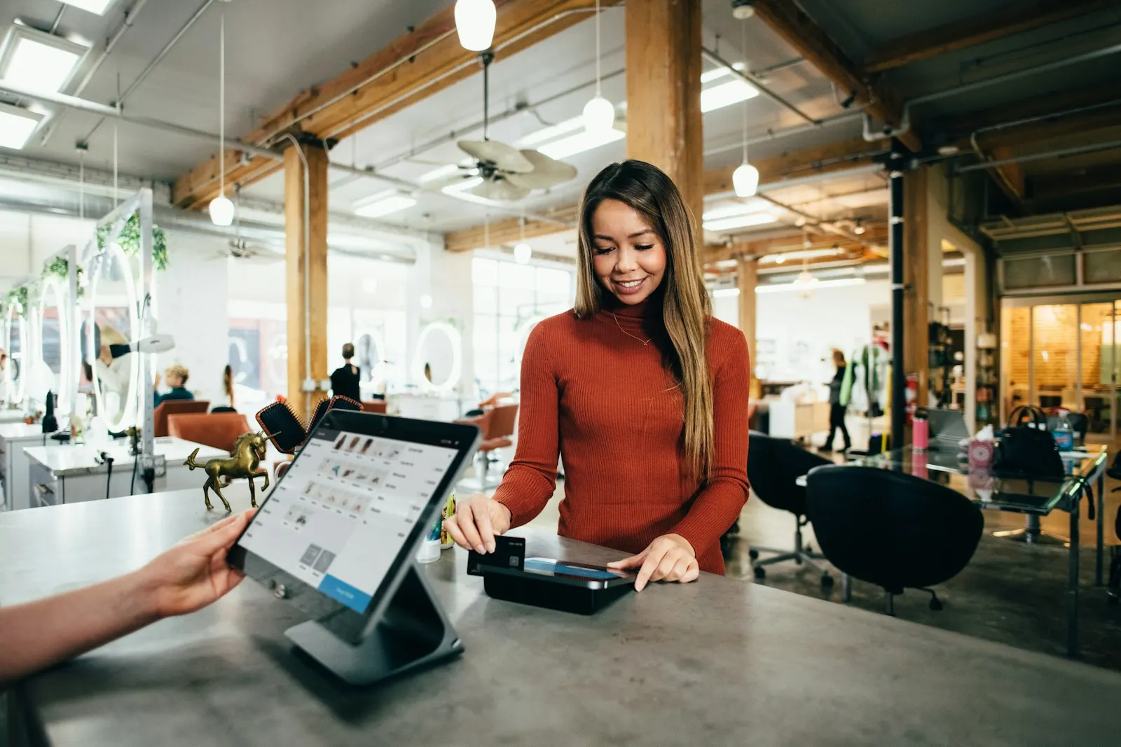 Customer paying by card at a shop counter